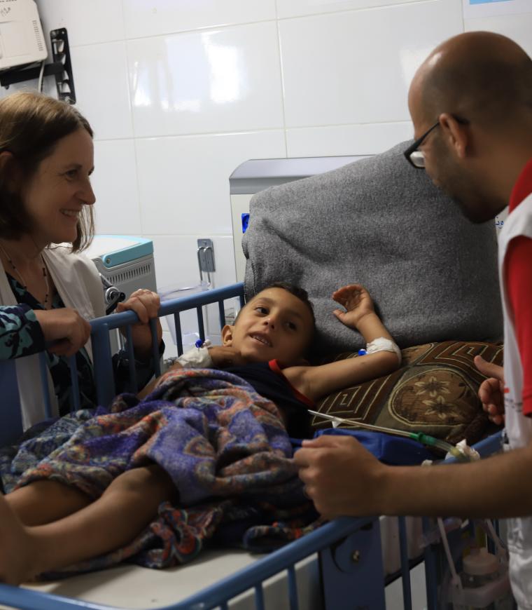 Mohammad Shihada, Nurse Team Supervisor, and Joanne Perry, Project Medical Referent in Gaza, checking on a a patient receiving treatment after being injured in Gaza.