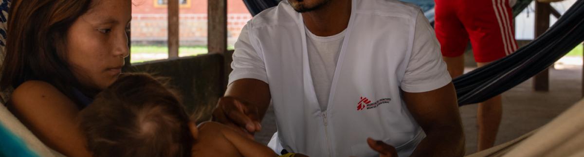 Reydanner Blez, promotor sanitario de MSF, realiza una visita de seguimiento sanitario en una maloca (gran vivienda comunitaria).