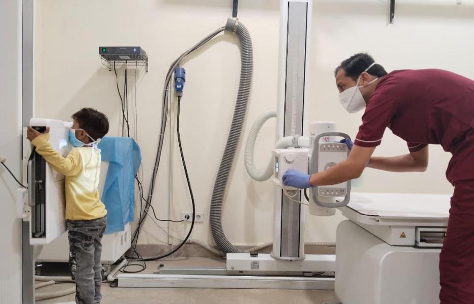 Un técnico de rayos X de MSF le hace una radiografía a un niño en la clínica de tuberculosis de MSF en el centro de salud rural Baldia, en Karachi, Pakistán, durante una revisión.